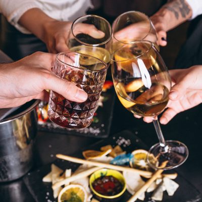 Male and female hands close up with cocktails